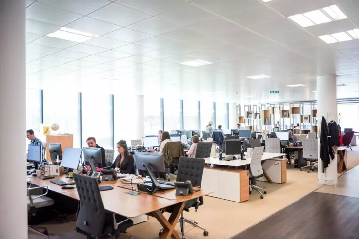 A vast open space filled with people working on computers.